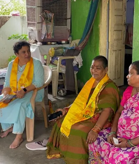 A seated conversation with women at their home, with an aide writing down the issues raised.