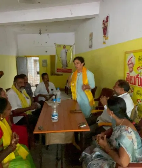 Krishna Priya addressing local cadre inside a Telugu Desam Party office, under a party banner.