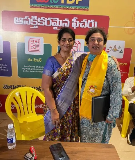 Krishna Priya with a fellow women's wing leader in front of a Mana TDP backdrop.